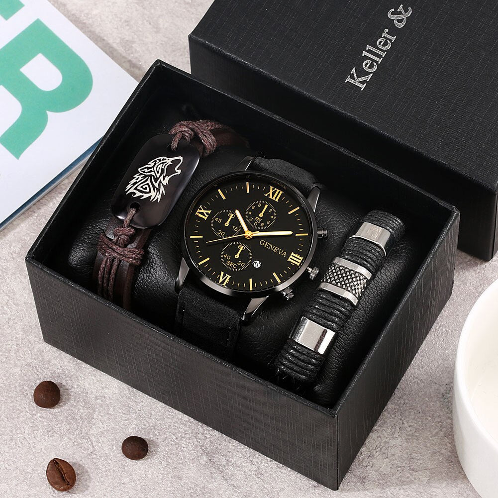 A men's watch gift set in an open black presentation box, featuring a black leather strap chronograph watch with a black dial and gold-tone Roman numerals, a dark brown braided bracelet with a wolf emblem, and a black-and-silver striped compression sleeve. 