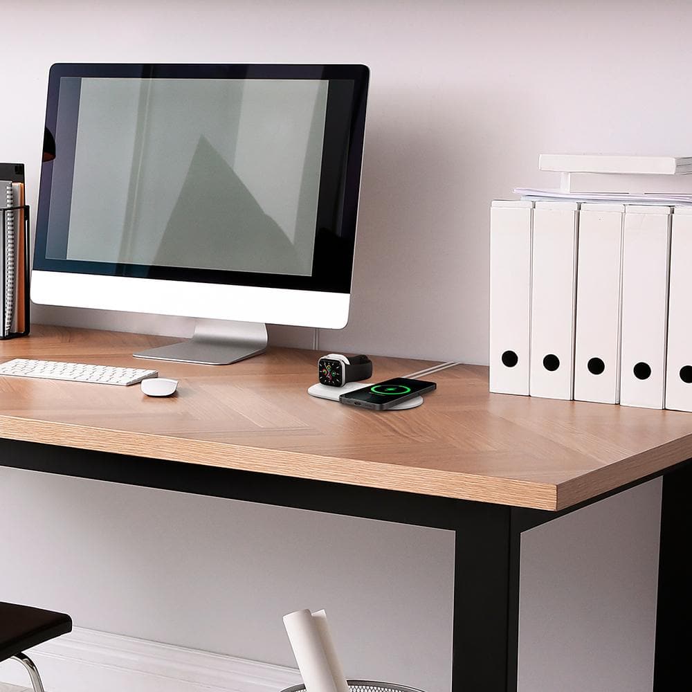 Mag Fit Duo in white showing Apple Watch and iPhone charging on top of computer desk
