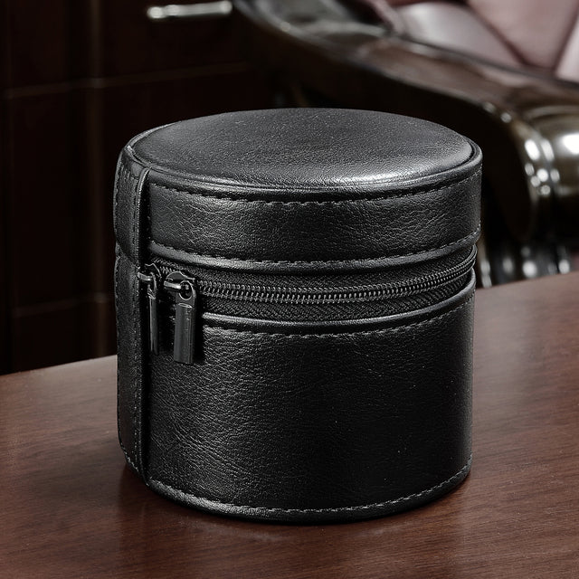 Black leather jewelry box with a zipper on a wooden surface