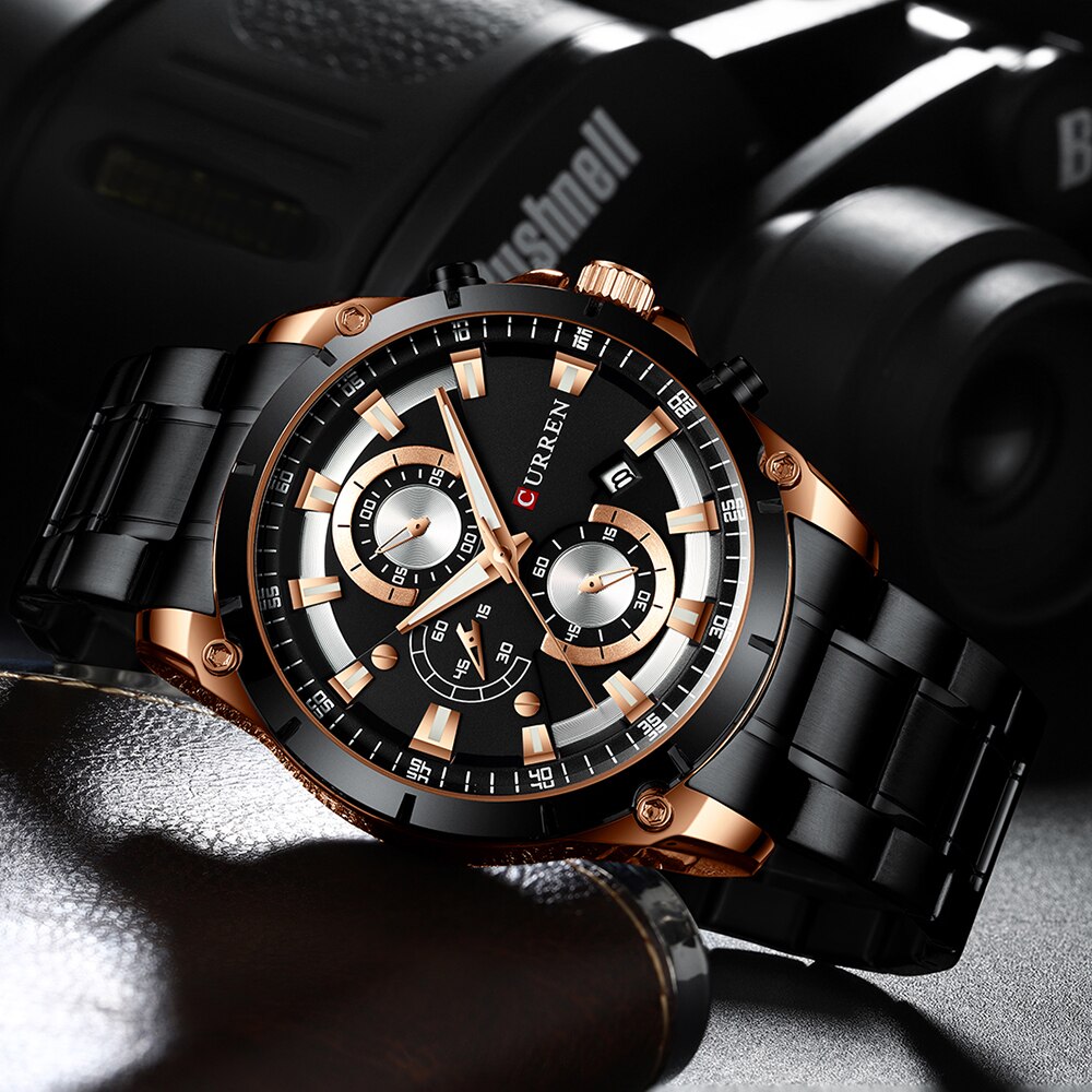 Luxury watch with black and rose gold design on a dark background